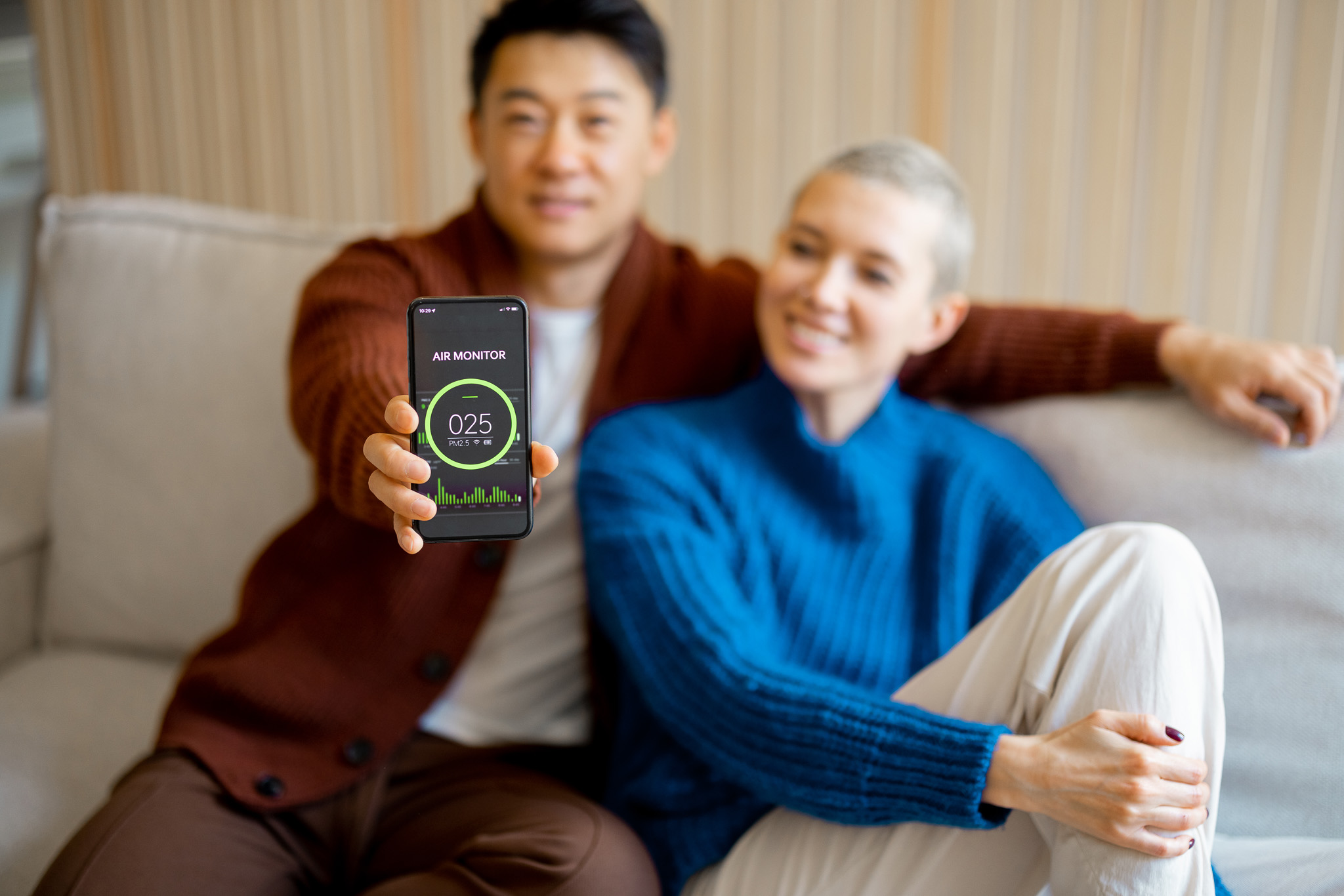 Man showing home air condition app on smartphone