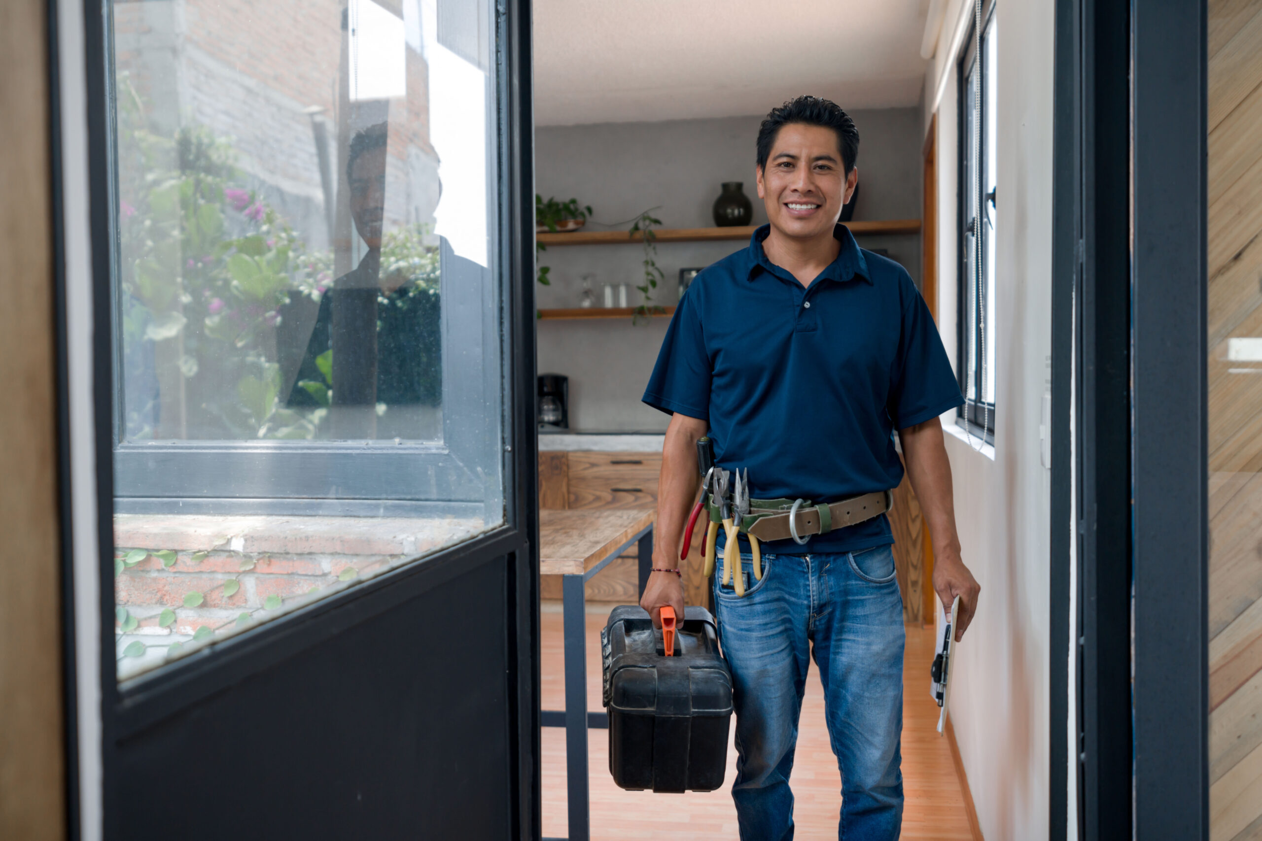 Happy plumber or electrician arriving home after a house call